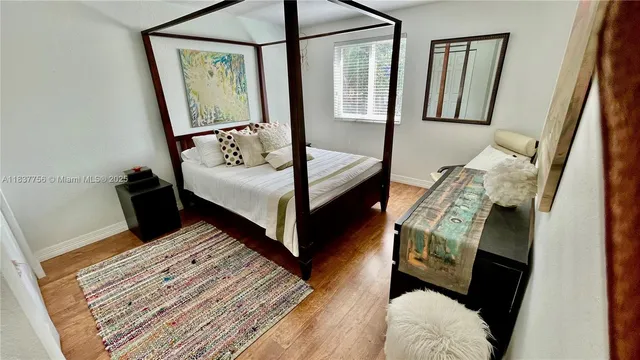 a bedroom with a bed and a mirror