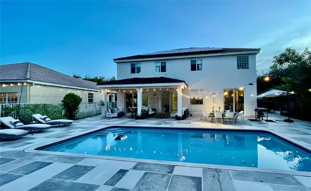 a view of swimming pool with outdoor seating