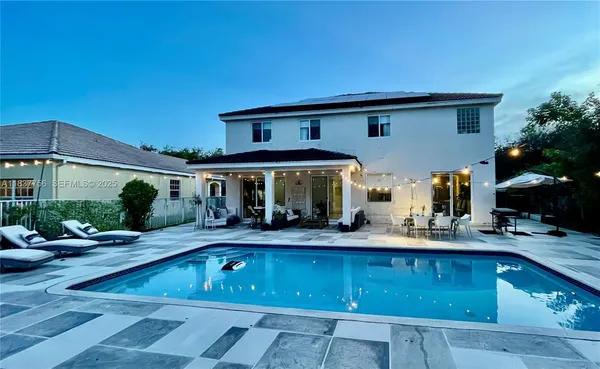 a view of swimming pool with outdoor seating