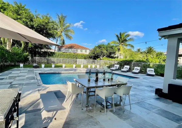 a view of a patio with table and chairs potted plants with wooden floor