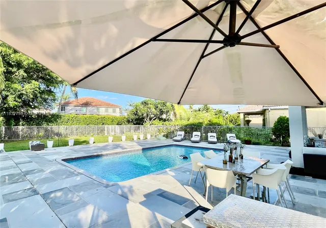 a view of a patio with table and chairs potted plants with wooden floor