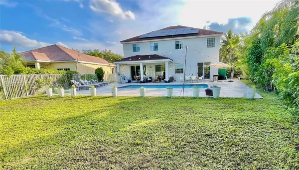 a front view of a house with a yard table and chairs
