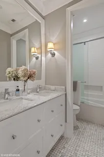 a bathroom with a granite countertop sink a toilet and a large mirror