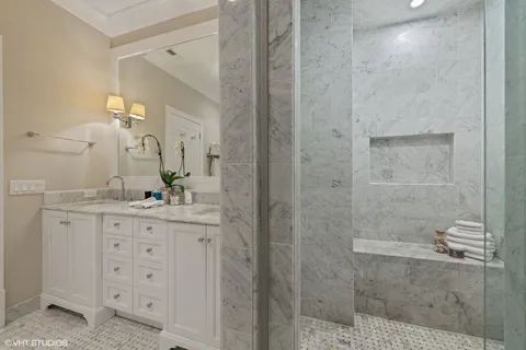 a bathroom with a granite countertop sink a mirror and a shower