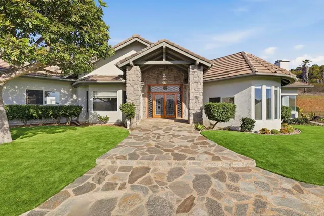 a front view of a house with garden