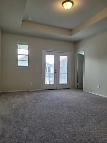 an empty room with windows and closet