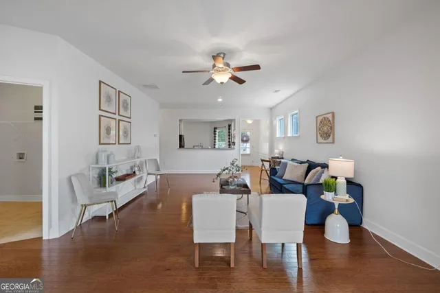 a living room with furniture and wooden floor