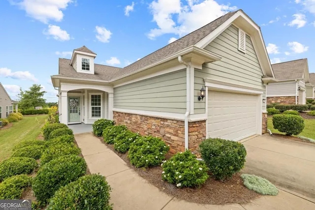 a front view of a house with garden