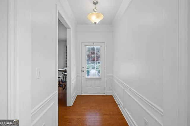 a view of an entryway with wooden floor
