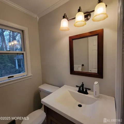 a bathroom with a sink a mirror and a toilet