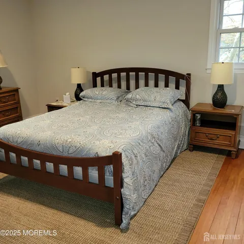 a bed sitting in a bedroom next to a window