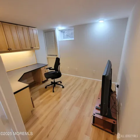 a room with gym equipment on wooden floor