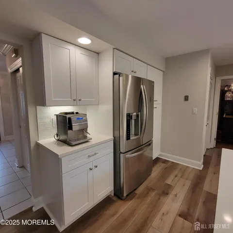 a kitchen with a refrigerator sink and cabinets