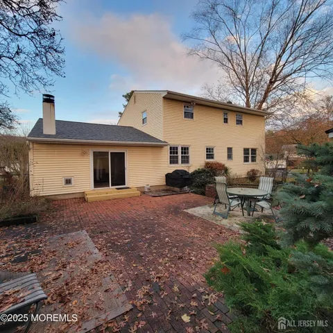a view of a house with backyard and sitting area