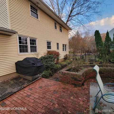 a view of a backyard with sitting area
