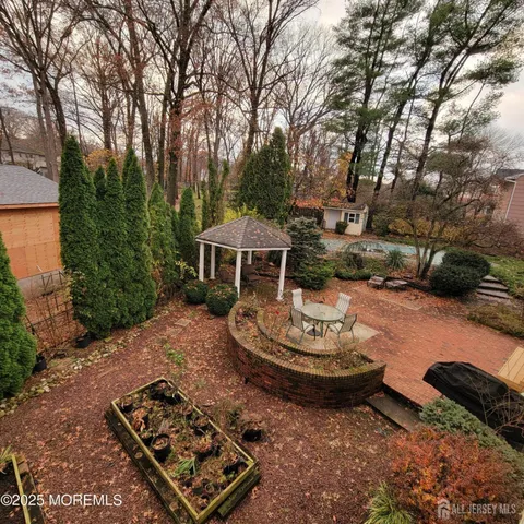 a view of a backyard with table and chairs and a fire pit