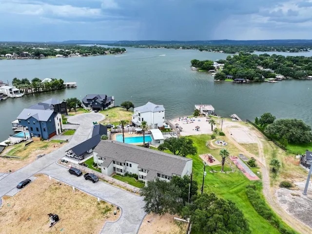 an aerial view of a house with a lake view