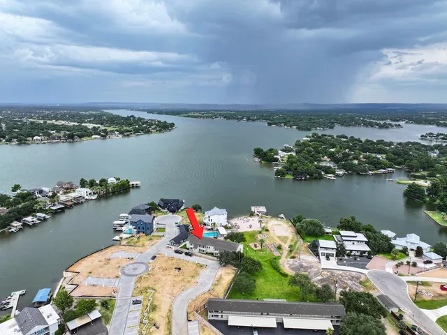 a view of a lake with a table and a chairs