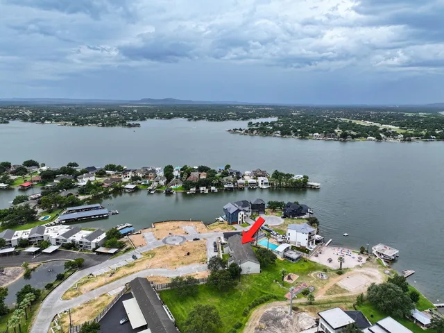 a view of a lake with a table and chairs