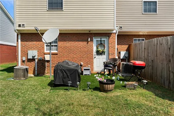 a view of a chair and table in backyard of the house