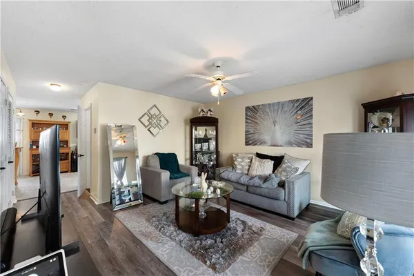 a living room with furniture and wooden floor