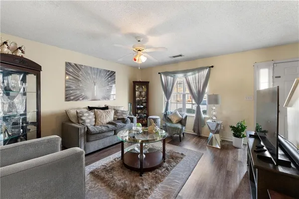 a living room with furniture potted plant and a window
