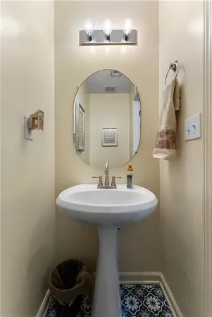 a bathroom with a sink a toilet and mirror