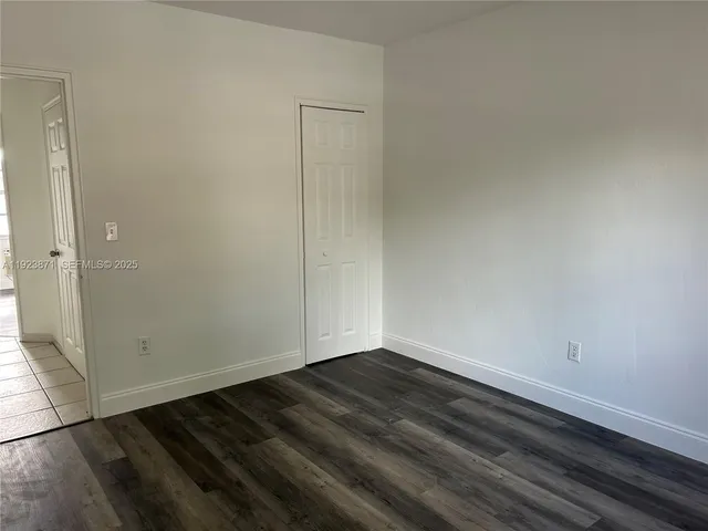 a view of a closet with wooden floor