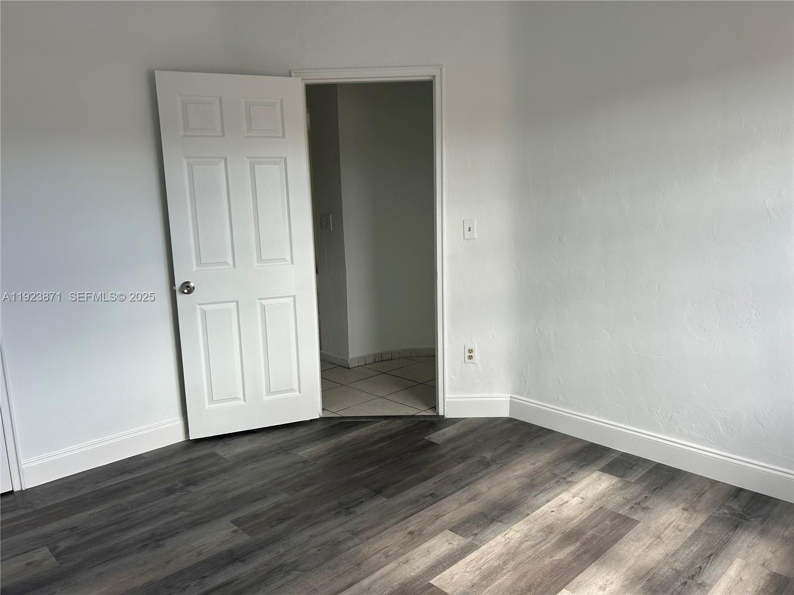 3400 Southwest 9th Terrace, Unit 2B Miami, FL 33135 - Photo 16 of 25 an empty room with wooden floor & closet area