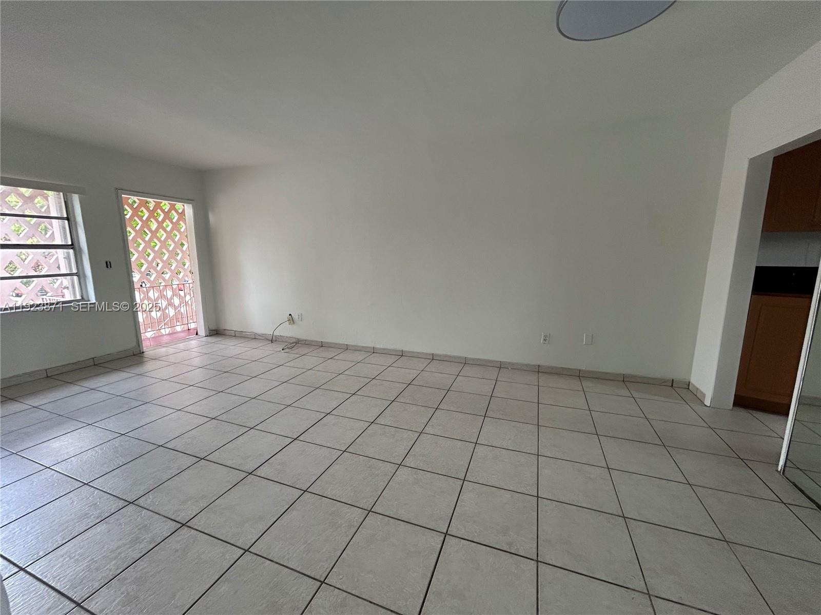 3400 Southwest 9th Terrace, Unit 2B Miami, FL 33135 - Photo 17 of 25 an empty room with windows