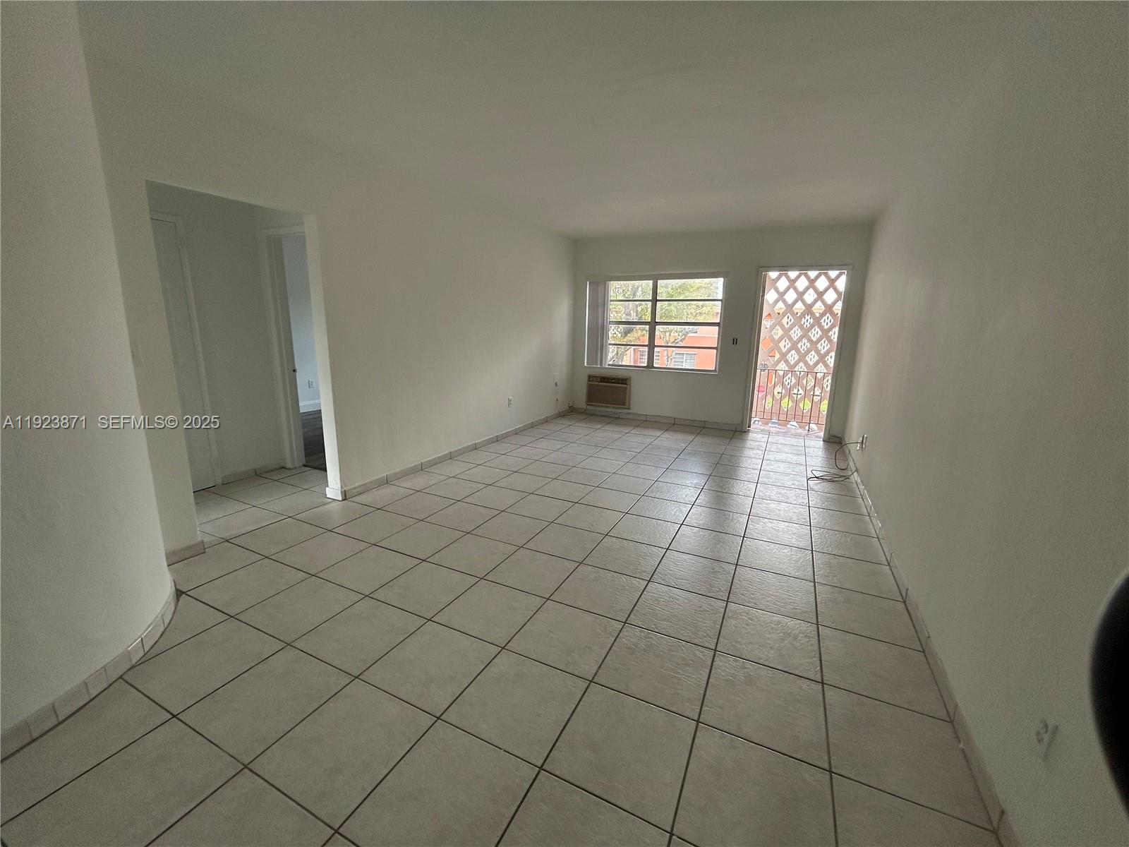 3400 Southwest 9th Terrace, Unit 2B Miami, FL 33135 - Photo 18 of 25 a view of an empty room and window