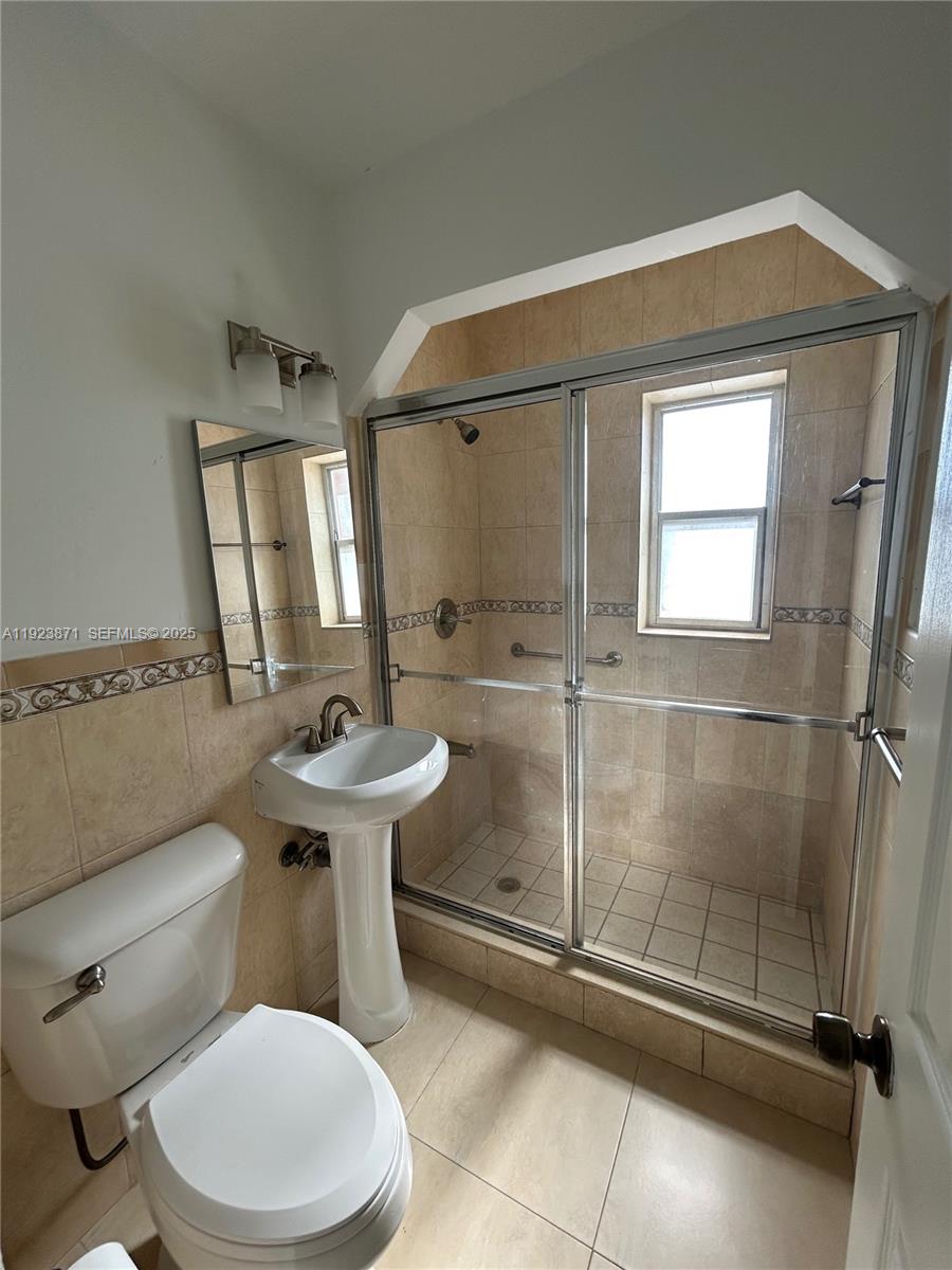 3400 Southwest 9th Terrace, Unit 2B Miami, FL 33135 - Photo 22 of 25 a bathroom with a sink a toilet and shower
