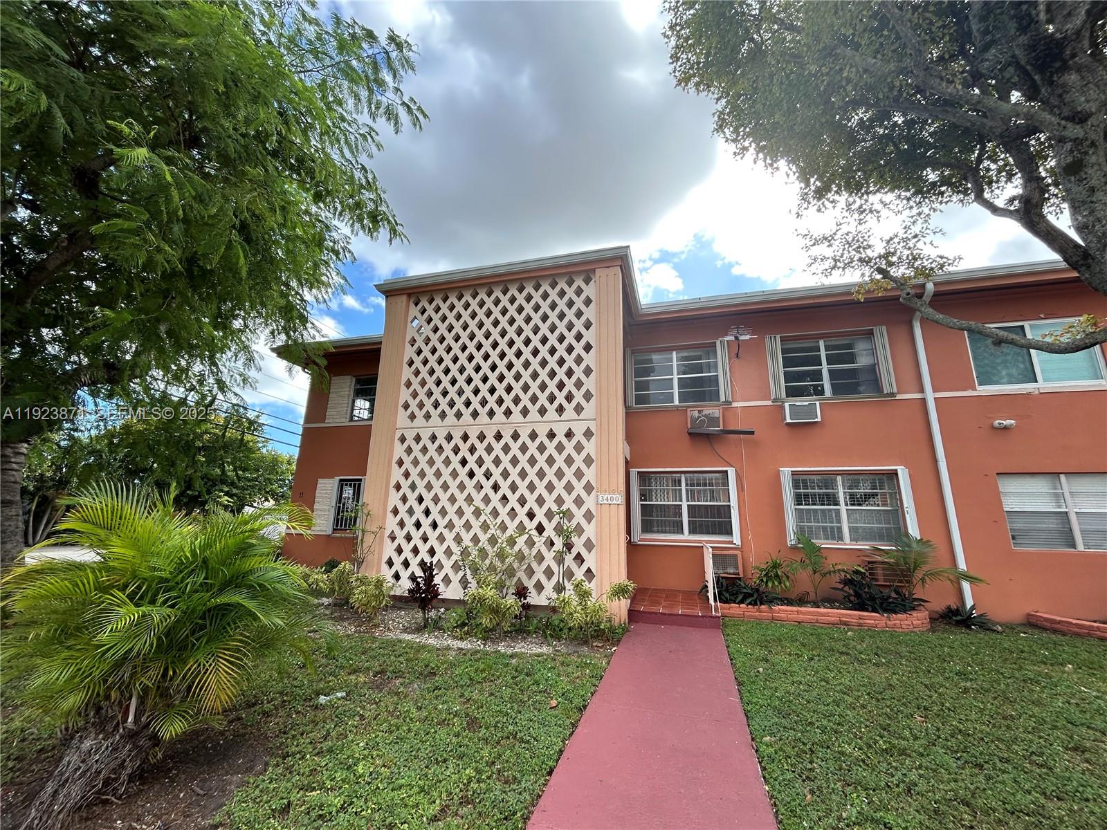 3400 Southwest 9th Terrace, Unit 2B Miami, FL 33135 - Photo 24 of 25 a front view of a house with a garden