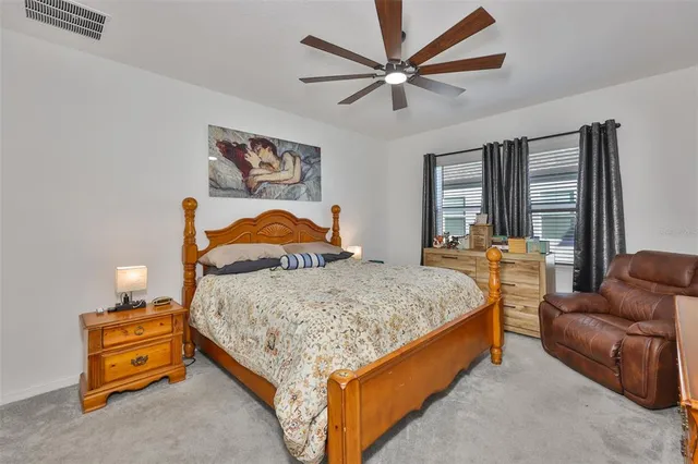 a bedroom with a bed and painting on the wall