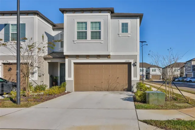 a living room with furniture a window and a flat screen tv