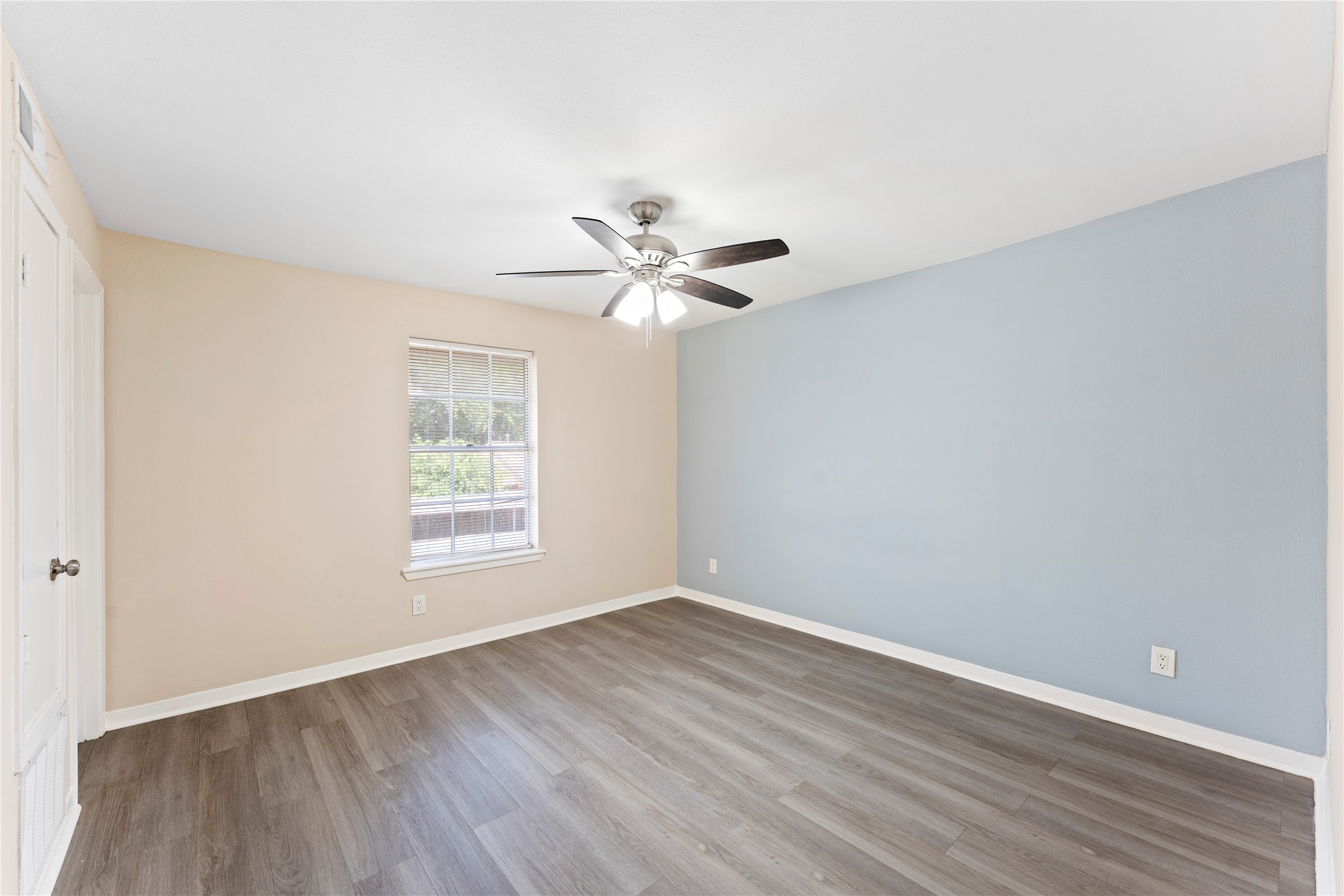 3316 Burke Road, Unit 43 Pasadena, TX 77504 - Photo 11 of 15 an empty room with wooden floor and windows