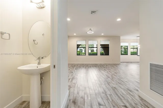 a view of a room with wooden floor and windows