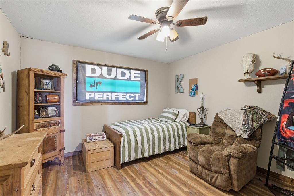 8145 Blair Road Northlake, TX 76247 - Photo 13 of 34 a bedroom with a bed and wooden floor