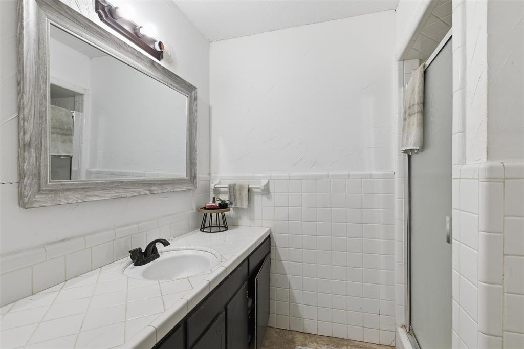 8145 Blair Road Northlake, TX 76247 - Photo 16 of 34 a bathroom with a sink and a mirror