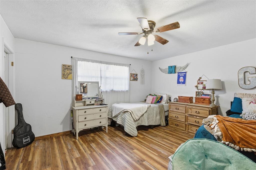 8145 Blair Road Northlake, TX 76247 - Photo 17 of 34 a bedroom with furniture and a wooden floor
