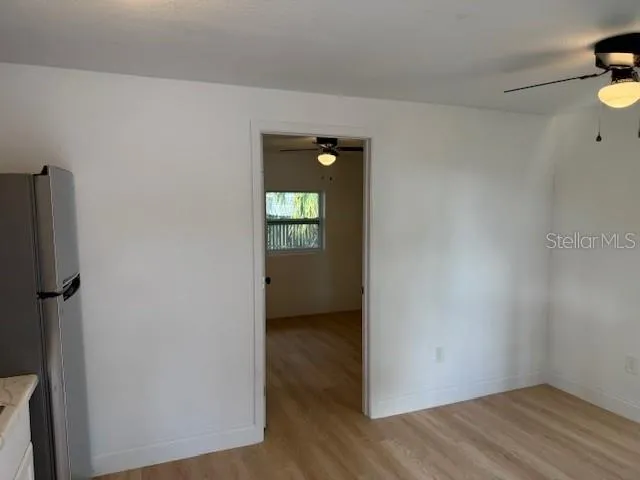 a kitchen with stainless steel appliances granite countertop a refrigerator a stove a sink and a microwave