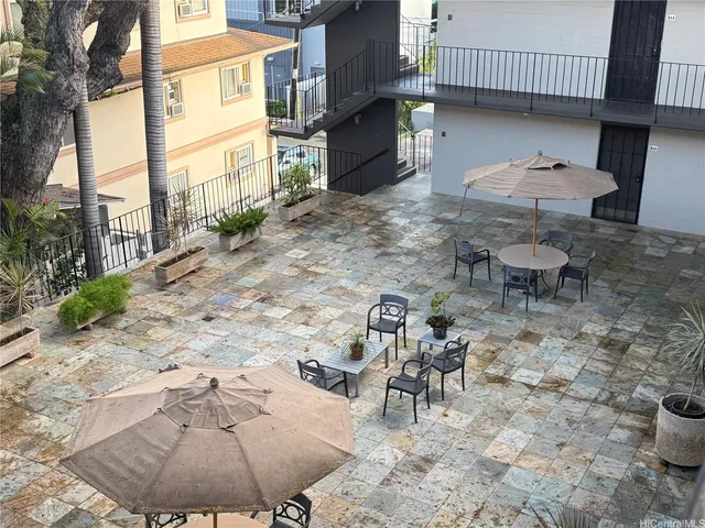 a view of a patio with a table and chairs
