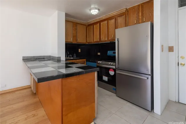 a kitchen with a refrigerator a stove and a microwave