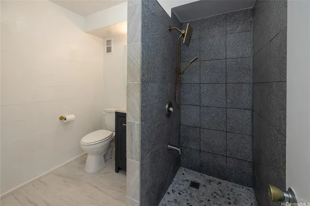 a bathroom with a toilet and a shower