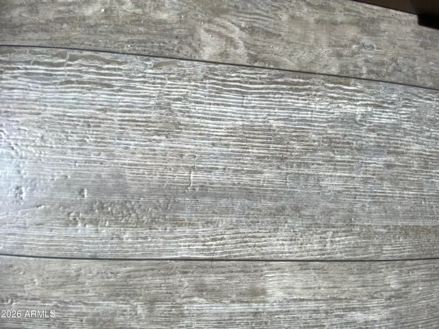 a bedroom with a bed and a flat tv screen on dresser