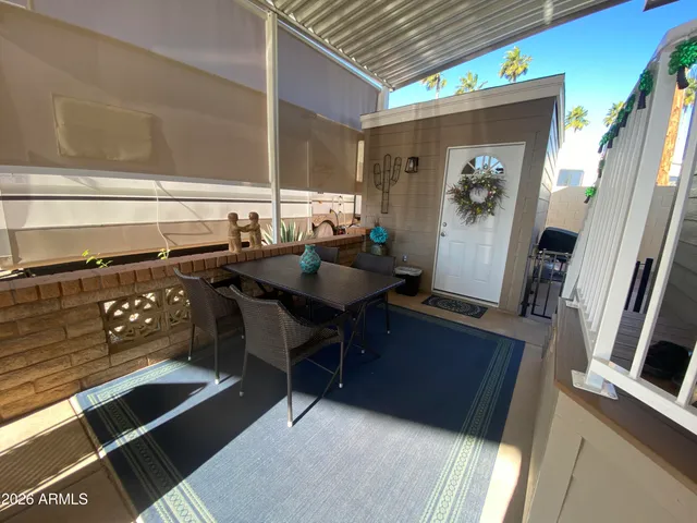 a view of a patio with a table and chairs