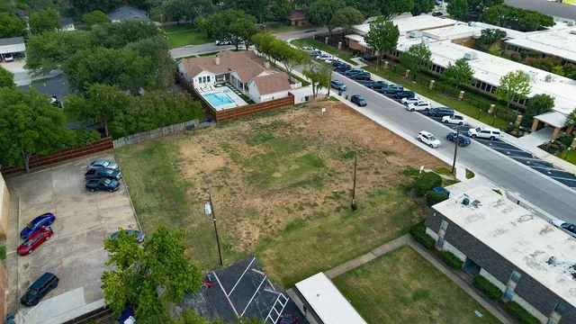 an aerial view of a house with a yard and lake view