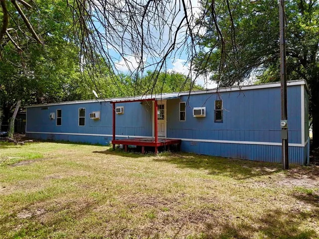 a view of a backyard with a large tree