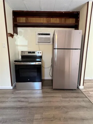 a kitchen with a refrigerator and a stove