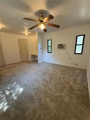 a view of a big room with a ceiling fan